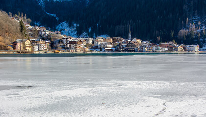 the frozen lake in the Dolomites with the small town of Misurina in the background