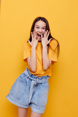 beautiful girl in a yellow t-shirt emotions summer style isolated background