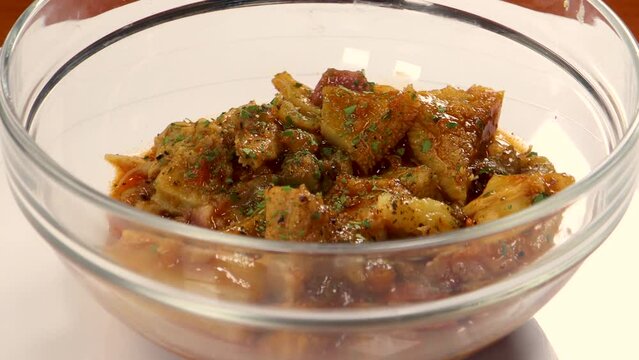 Spanish tripe food callos in clear glass bowl. Tasty traditional Madrid dish, mediterranean food. Juicy pork meat. Rotating.