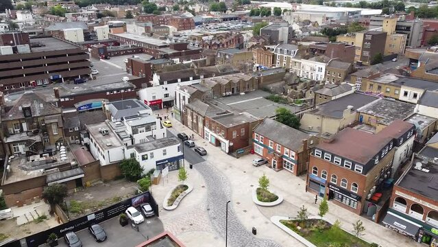 Drone view above the building roofs in the city of Dartford, Kent, England. Aerial pan left shot