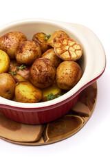 Baked potato in a clay pot isolated on white background