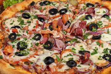 Pizza with bacon and cheese, herbs and cherry tomatoes. With mozzarella, shrimps and octopuses, mussels and other products on a wooden background.