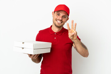 pizza delivery man with work uniform picking up pizza boxes over isolated  white wall happy and counting three with fingers