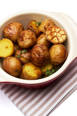 Baked potato in a clay pot isolated on white background