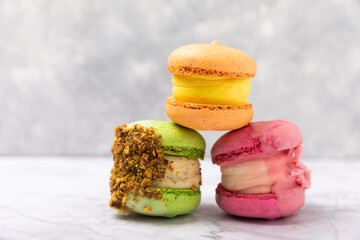 Tasty macarons on a marble background. colorful almond berry cookies.Culinary and cooking concept.Side view.Copy space.