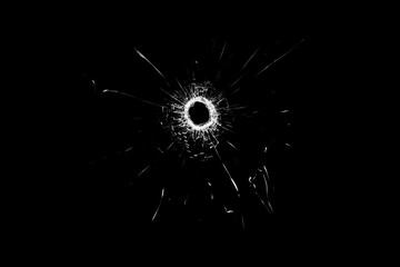 Obraz premium Texture of broken glass. Hole from a ball on a black background.