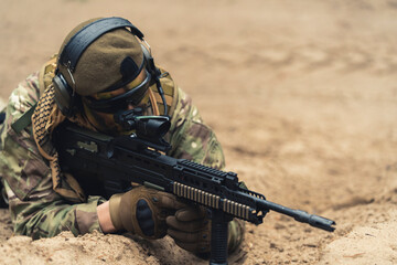 Accurate scoop aim by field veteran soldier on ground . High quality photo
