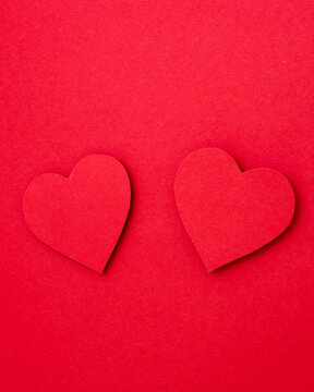 red hearts on a red background, copy space, two red hearts, Valentines day, vertical photo