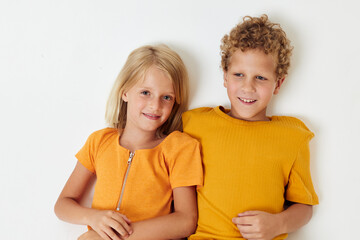 funny kids boy and girl in yellow t-shirts Studio light background