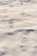 footprints on the snow under sunlight close-up