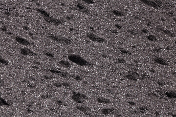 Black grey sponge textured background. Foam rubber background