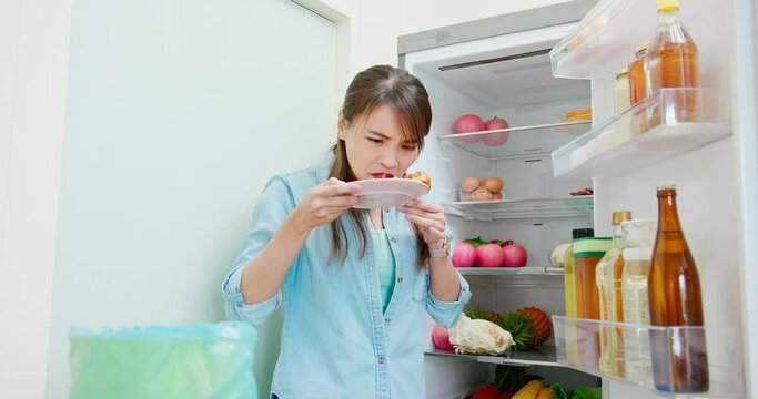 woman is pouring food waste