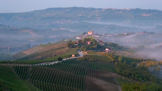 Grinzane Cavour time lapse in Langhe vineyard and Medieval castle, Piedmont Italy timelapse fog mist