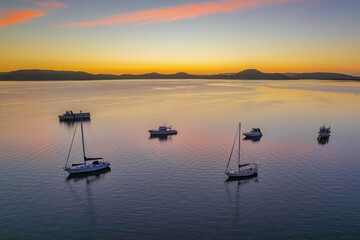 Aerial sunrise waterscape with boats