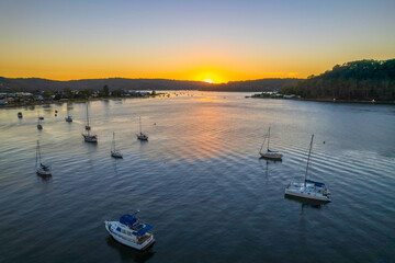 Aerial sunrise waterscape with boats and clear skies