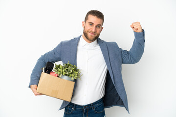 Young caucasian making a move while picking up a box full of things isolated on white background...