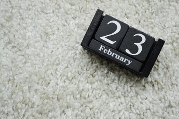 Wooden calendar from blocks on white background with copy space.23rd of February