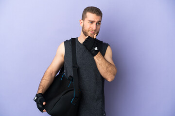 Young sport man with sport bag isolated on white background having doubts and thinking