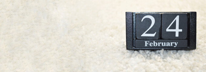 Obraz premium Wooden calendar from blocks on white background with copy space.24th of February