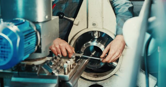 Engineering inspection checks the dimensions of engineering parts with a caliper in an industrial factory