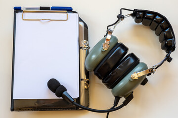 Pilot's kneeboard and flight headset as an airline or flight school concept.
