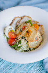 Fresh Caesar salad with croutons, cream and cheese