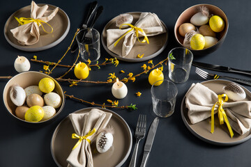 easter, holidays, tradition and object concept - close up of dinner party table serving over black background