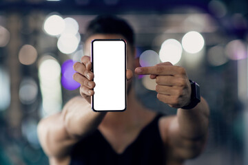 Unrecognizable Male Athlete Holding And Pointing At Blank Smartphone, Recommending Fitness App