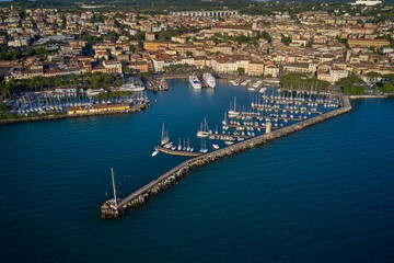 Fototapeta premium Italian resorts on Lake Garda. Porto vecchio in Desenzano del Garda, Italy. Desenzano, lago di Garda view by drone. Desenzano del Garda in italy. 