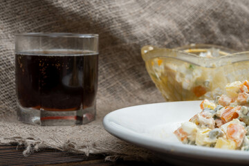 Russian traditional Olivier salad with vegetables and meat. Winter salad for New Year and Christmas. close-up, selective focus.