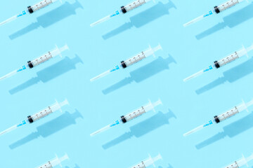 Medical syringes on a blue background. Healthcare pharmacy and medicine concept