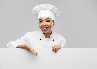 cooking, advertisement and people concept - happy smiling female chef with white board over grey background