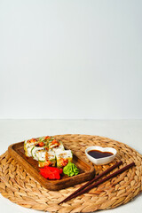 Fototapeta na wymiar Sushi rolls covered cucumber with fresh fish and copy space for text.