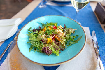 Salad with arugula and avocado is tasty vegeterian dish in the kitchen