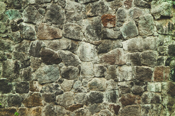 Abstract traditional stone wall pavement texture background. Bumpy textured stonewall made from flagstone and slabstone.