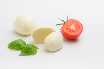 head of mozzarella cheese and red tomato on a white background
