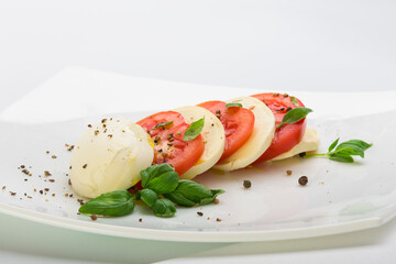 head of mozzarella cheese and red tomato sliced ​​on a white background