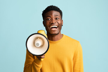 Cheerful black guy with megaphone making announcement