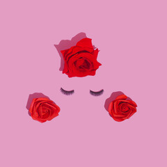 Abstract female face with false eyelashes and red roses hair. Love and make up concept flat lay.