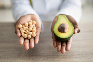 African american nutritionist recommending avocado and nuts as low-carb healthy fats foods good for weight loss diet