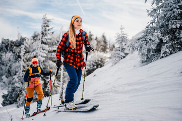 Mountaineer backcountry ski walking ski woman alpinist in the mountains. Ski touring in alpine...