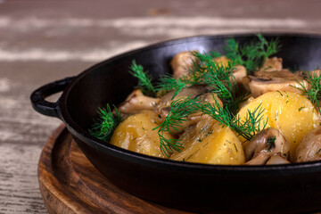 fried potatoes and mushrooms in a pan with parsley