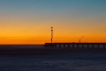 Obraz na płótnie Canvas pier after the sunset with sky and sea