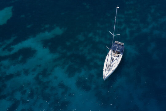 aerial view of yacht in turquoise waters 