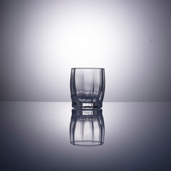 empty glass for vodka on gray background