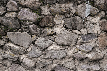 Abstract traditional stone wall pavement texture background. Bumpy textured stonewall made from flagstone and slabstone.