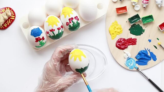 Paint the eggs with your own hands with bright colors for the Easter holiday.  Draw a picture on the eggs for the holiday. happy Easter