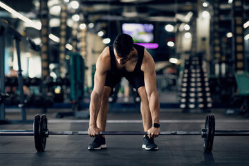 Fototapeta na wymiar Deadlift Workout. Portrait Of Muscular Arab Man Lifting Heavy Barbell At Gym