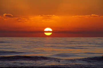sunset over the sea with clouds