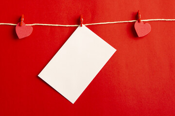 Hearts and card with blank space for text on red background. Flat lay, top view	